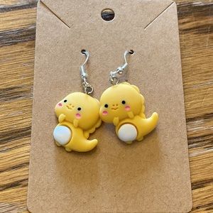 Yellow baby dinosaur with silver wires and random colored gift bag.